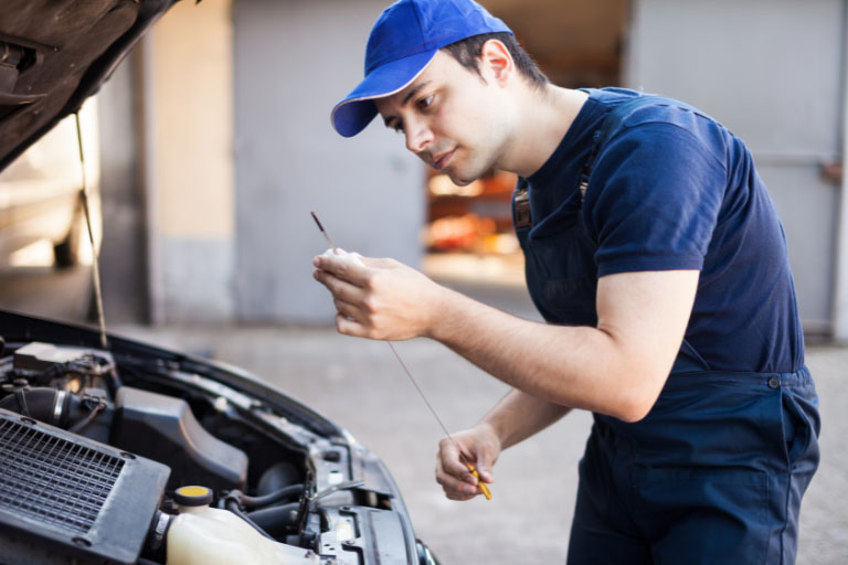Dipstick Oil Analysis: How to Check Engine Oil Using a Dipstick 3 A Man Checking Oil Level with Dipstick