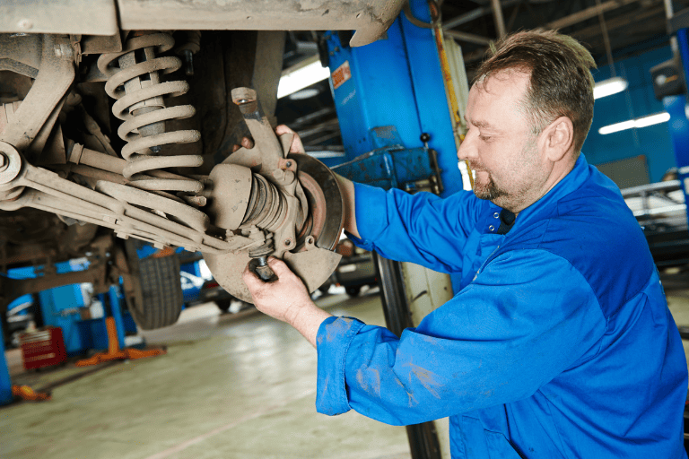A Mechanic Checking the Car Suspension