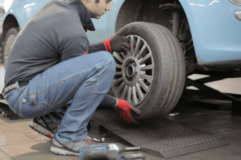 A Mechanic Checking the Car Tires