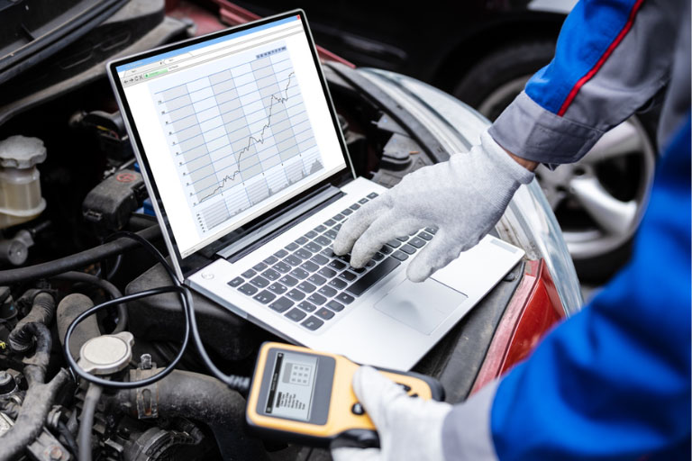 A Mechanic Using Advanced Diagnostic Equipment on a Car