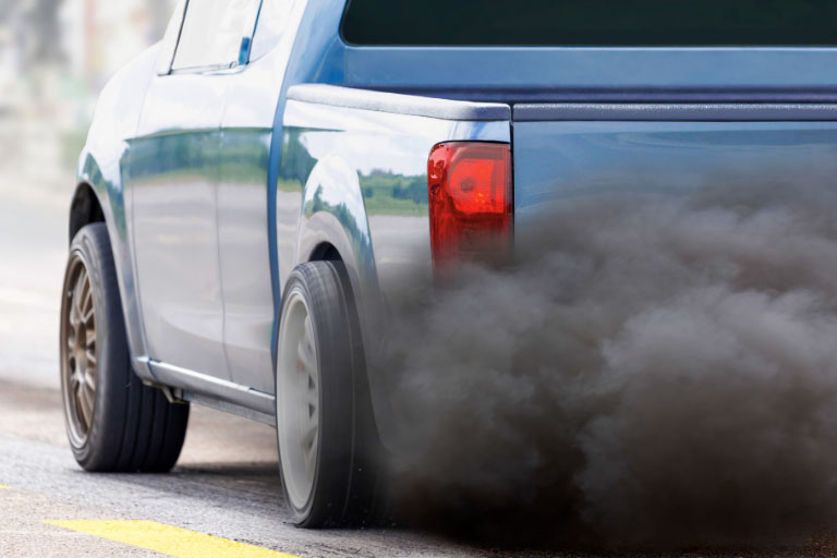Close-up of a Car Exhaust Emitting Black Smoke