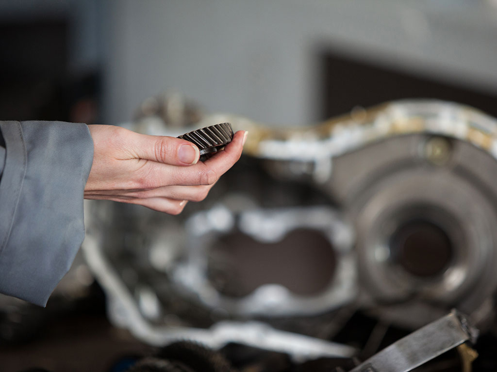 Top Causes of Low Oil Pressure in Car Engines 2 Mechanic Holding Bevel Gear