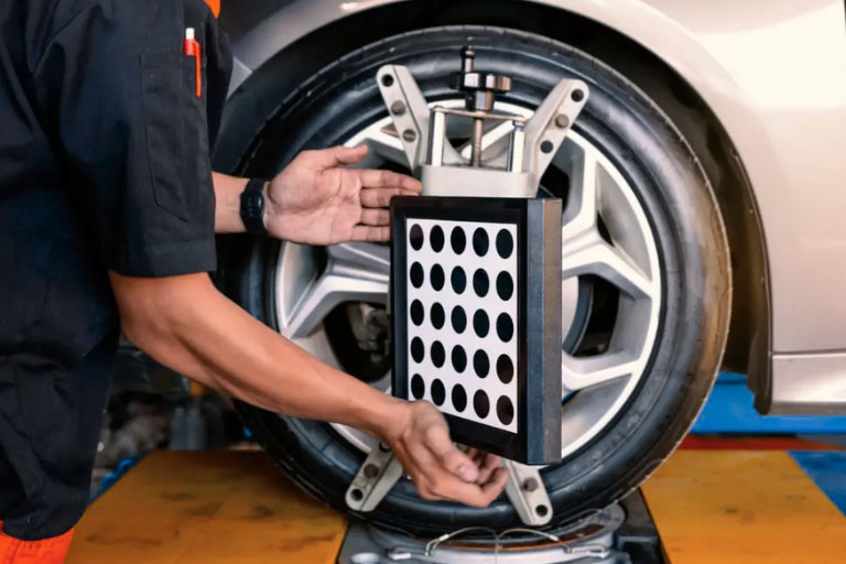 How Much Does a Wheel Alignment Cost in 2025? 2 A Mechanic Performing Wheel Alignment by Adjusting Suspension Angles