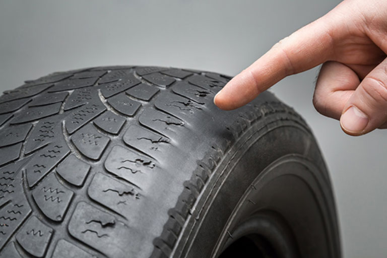 How Much Does a Wheel Alignment Cost in 2025? 4 Close-Up of Worn-Out Tires from Poor Alignment