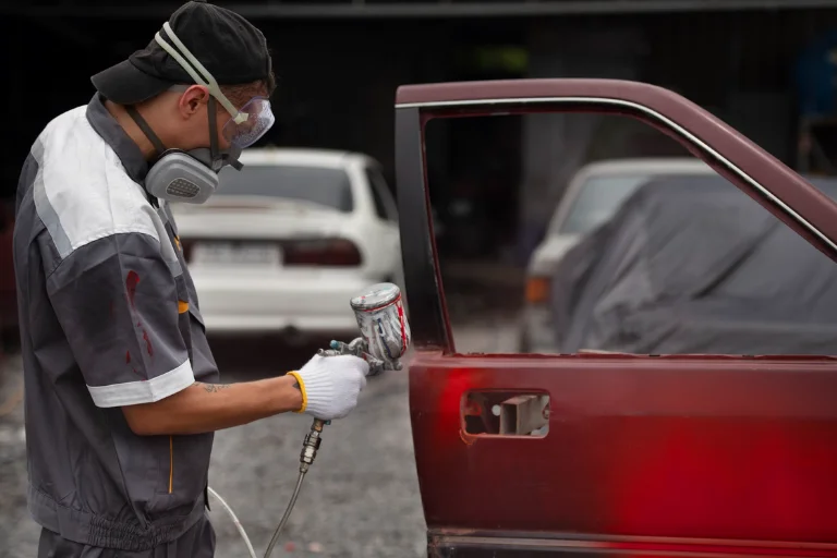 A Man Applying Touch-up Paint on a Car