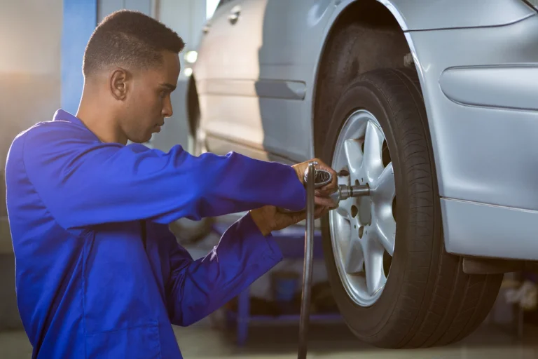 The Difference Between Front-End Alignment and Four-Wheel Alignment 2 A Mechanic Adjusting the Front Wheels of a Car