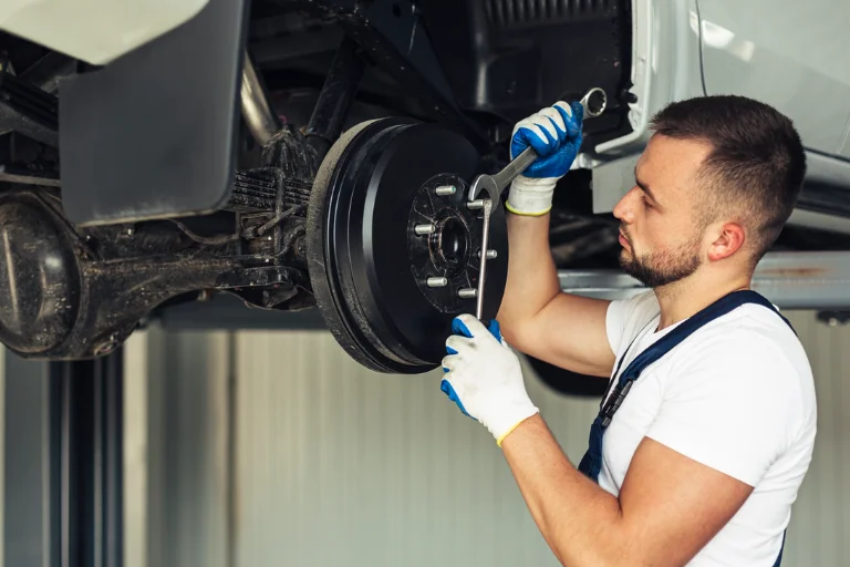 A Mechanic Performing Full Brake Service on a Car