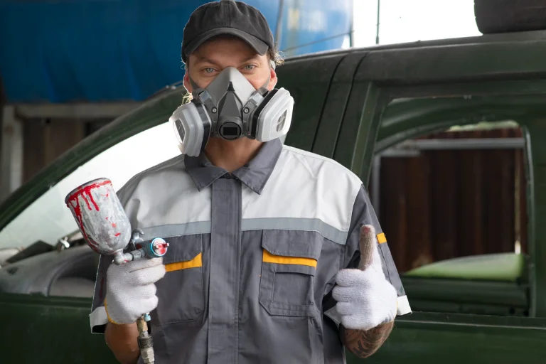 A Mechanic Performing a Scratch Repair at the Garage