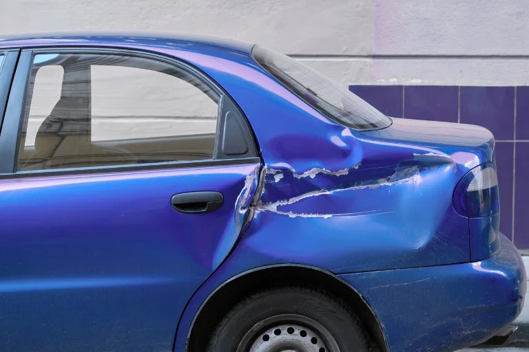 Close-Up of a Car with Visible Dents and Scratches