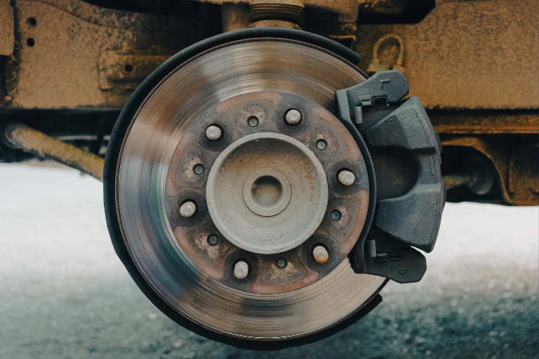 Top 5 Reasons Your Steering Wheel Shakes While Driving 4 Close-up of the Disc Brakes of the Car