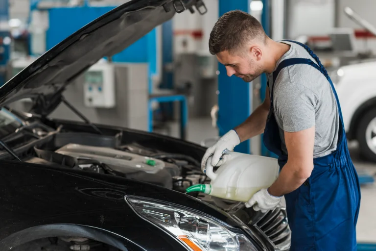 A Mechanic Replacing Engine Oil of a Car