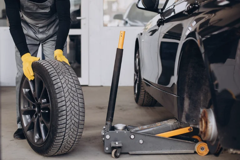 Mechanic Performing Wheel Balancing on a Balancing Machine