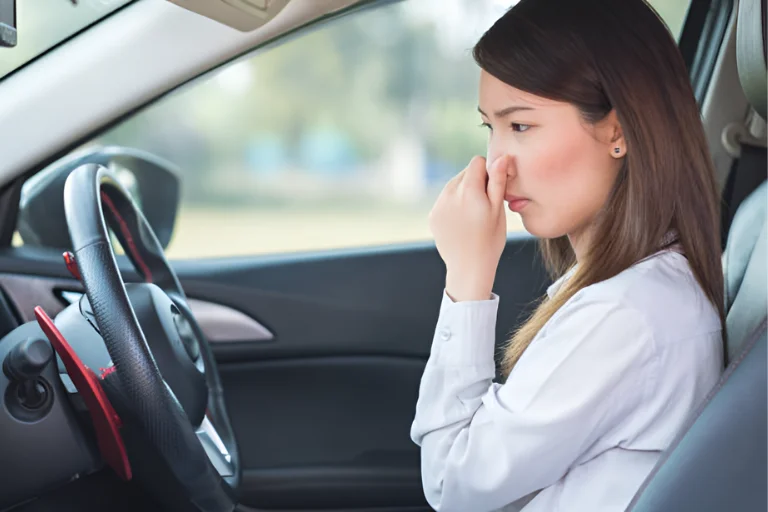 Woman Reacting to Unpleasant Smell from Car AC Vents