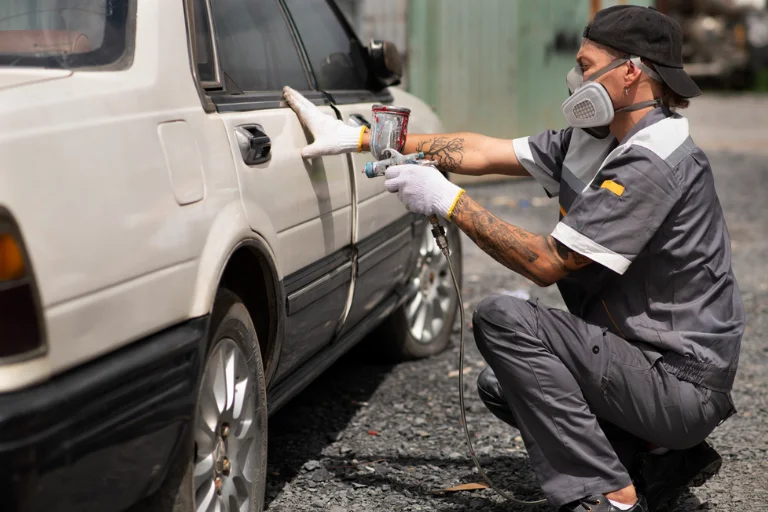 A Mechanic Applying Touch-Up Paint to Prevent Car Rust
