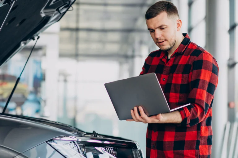 How to Choose a Reliable Mobile Mechanic in the USA 3 A Man Reading Mechanic Reviews on a Laptop