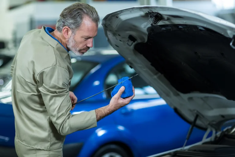 A Mechanic Checking Engine Oil During Mobile Car Maintenance