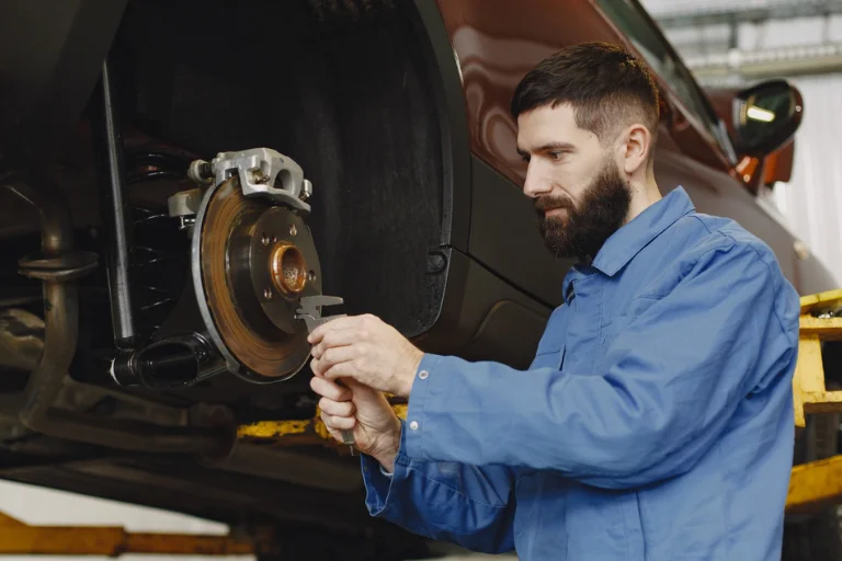 How to Choose a Reliable Mobile Mechanic in the USA 2 A Mobile Mechanic Checking the Brakes of a Vehicle