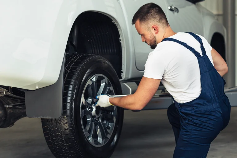 What Is a Mobile Mechanic and How Does It Work in the USA? 3 A Mobile Mechanic Inspecting Tire Tread and Pressure with Gauge