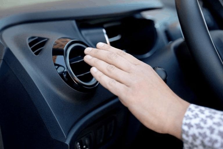 A Person Checking the airflow from the A/C Vents