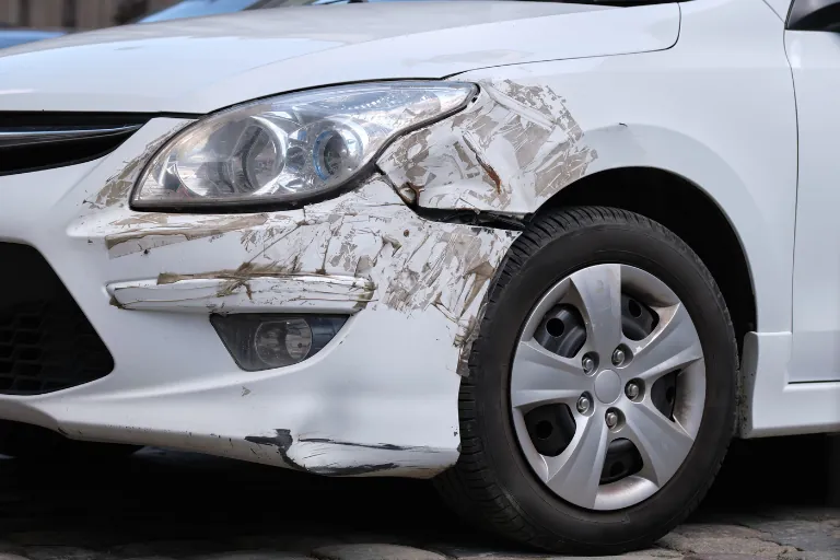 Scratches, Dents & Bodywork: Can a Mobile Mechanic Fix These in the USA? 3 A Close-Up of Small Dents and Scratches on the Bumper of a Vehicle