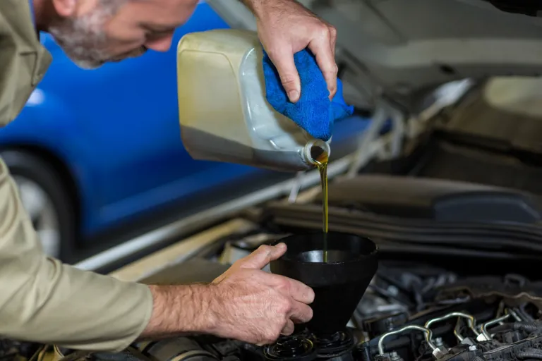 Mobile Oil Change Houston — We Come to You 3 A Close-up of a Mobile Mechanic Providing an Oil Change Service