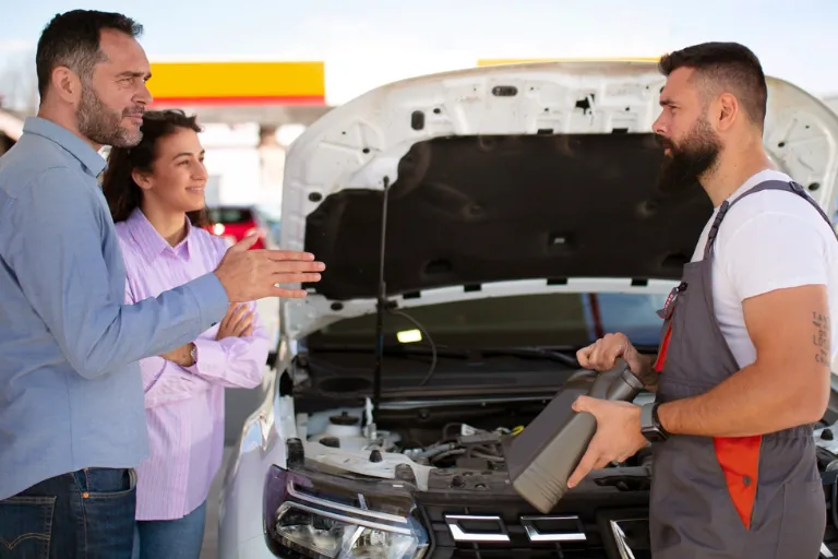 Mobile Oil Change Houston — We Come to You 4 A Mechanic Showing Engine Oil Quality to a Car Owner