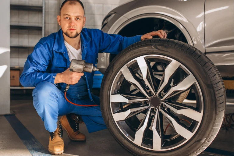 A Mobile Tyre Fitting Service Technician Replacing the Car Tyre