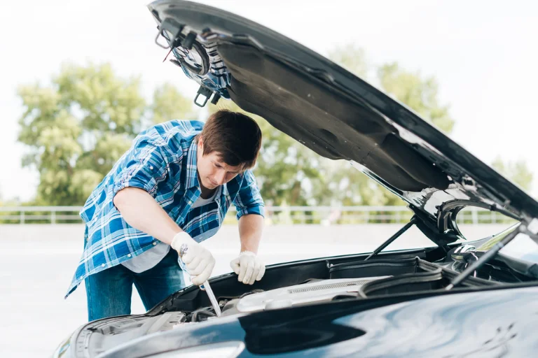 A Man Performing Winter Car Maintenance in Massachusetts
