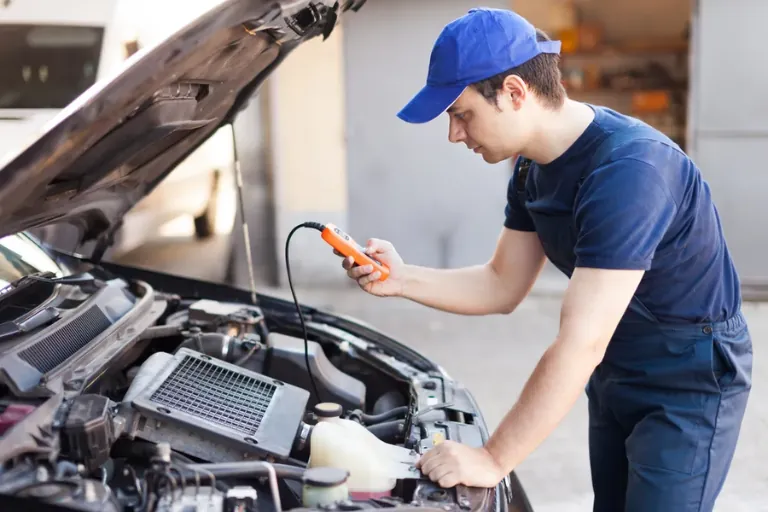 A Mechanic Performing On-Site Vehicle Diagnostics Using an OBD Scanner