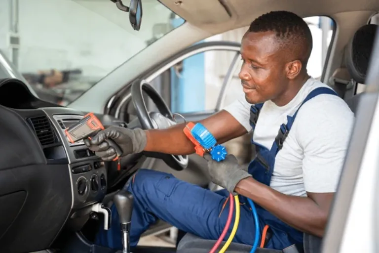 A Mobile Mechanic Miami Checking the Car AC system with a Pressure Gauge