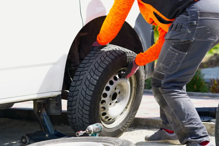 A Mechanic Changing the Tire of a Commercial Vehicle