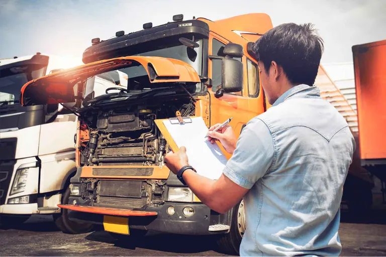Fleet Maintenance Company Houston TX — What to Look For 2 A Technician Inspecting Multiple Commercial Vehicles