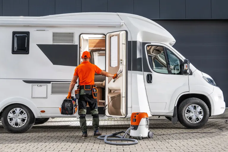 A Technician Repairing an RV at a Roadside Location