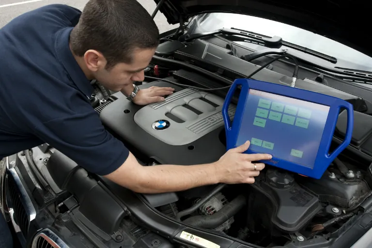 A Technician Using a Diagnostic Tool on a Vehicle