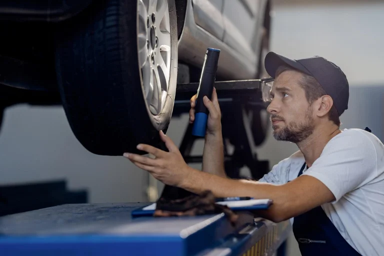 Fleet Vehicle Inspection Checklist: What to Check Every Month 4 A Mechanic Identifying Worn Tires of a Fleet Vehicle