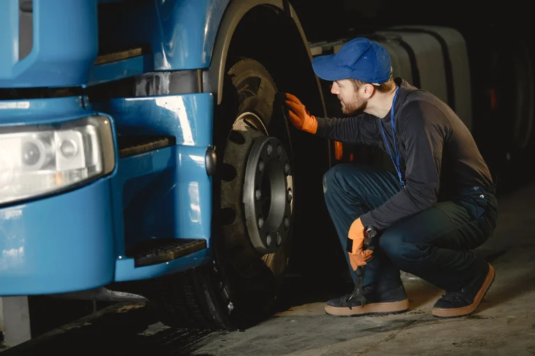 A Mechanic Inspecting an Aging Fleet Truck