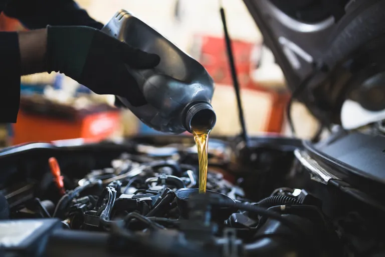 A Mechanic Performing an Engine Oil Change on a Commercial Vehicle