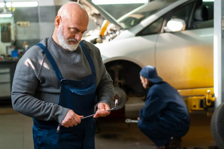 Fleet Vehicle Inspection Checklist: What to Check Every Month 2 Technician Performing a Safety Inspection on a Fleet Vehicle