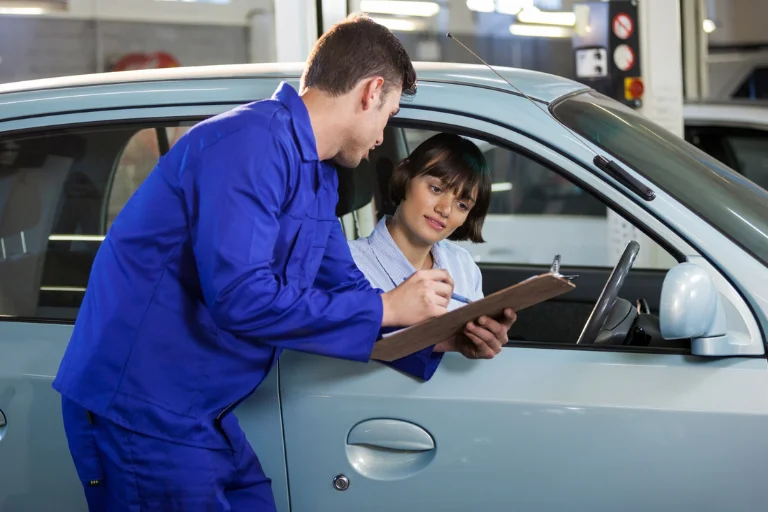 Fleet manager reviewing a maintenance checklist with a customer