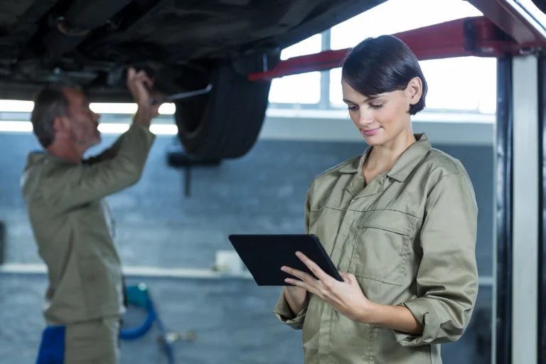 Mechanic using a digital maintenance checklist during inspection
