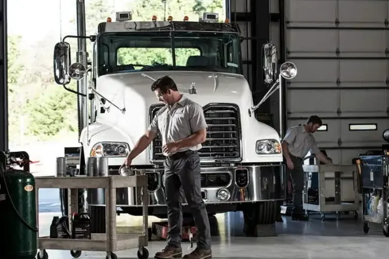 Technician performing fleet service repair on a commercial vehicle