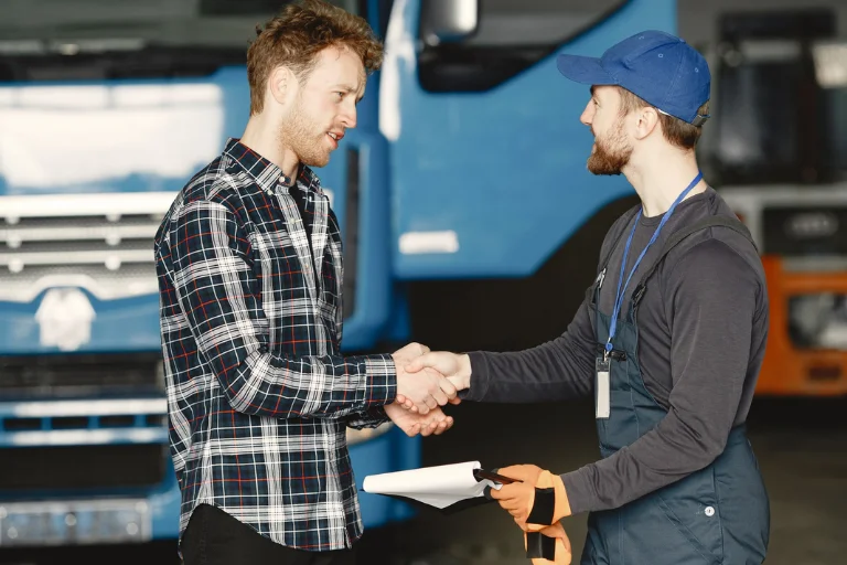 Fleet owner consulting with a diesel service technician