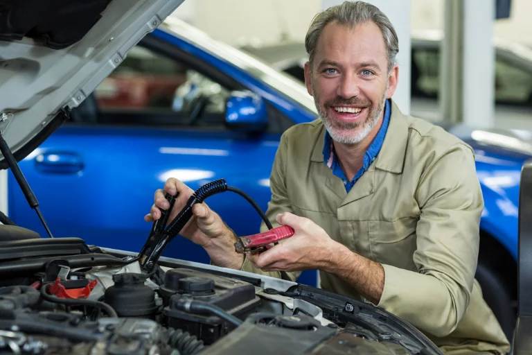 Mechanic inspecting battery terminals and testing voltage