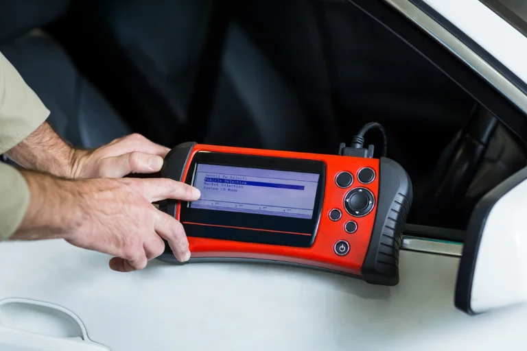 Technician using a multimeter or diagnostic tester on battery charging system
